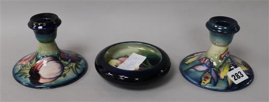 A pair of Moorcroft candlesticks and a bowl